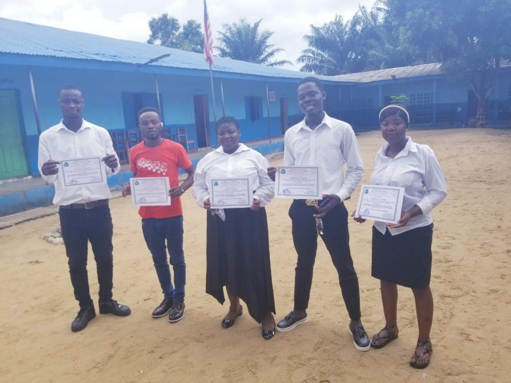 Teachers at Damiefa School holding their certificates