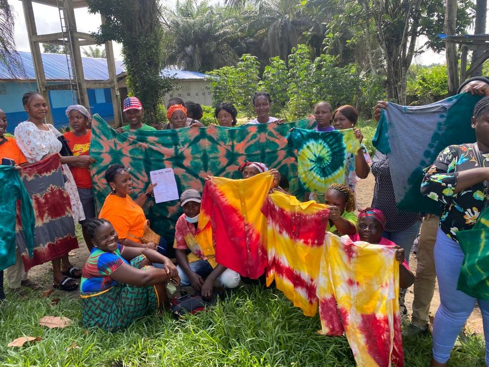 members of Mineke Foundation's Women's Club showcase tie and dye products they made