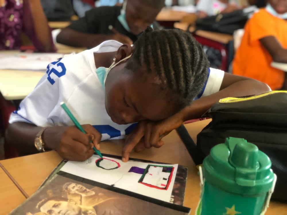 A student works on art at Damiefa School