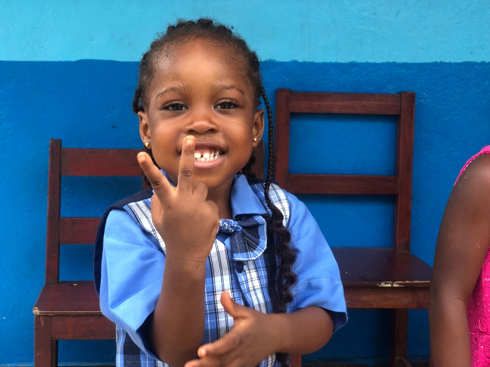 A smiling female student at Damiefa School in Liberia