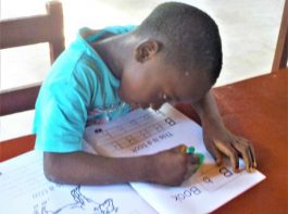 Damiefa School - boy learning to write